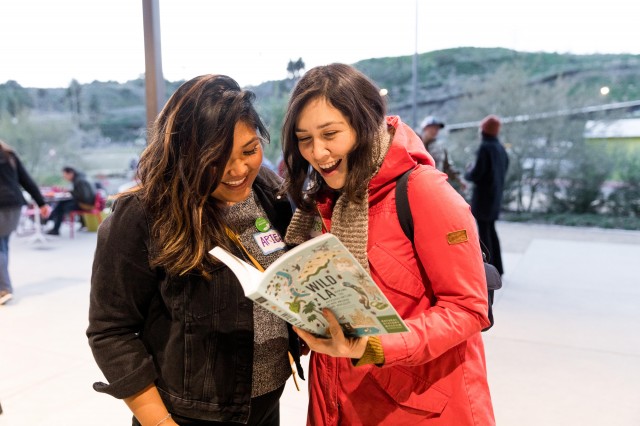 two women reading Wild LA book at community science super project party