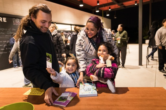 Family enjoying raffle prizes at a party at night