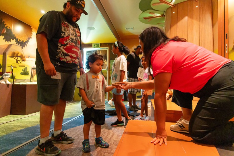 Father and son welcomed by Nicole Duran in the Tar Pits Mobile Museum