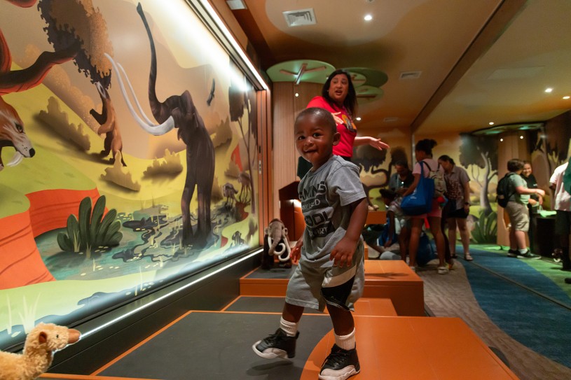 A small child plays in the new Tar Pits Mobile Museum