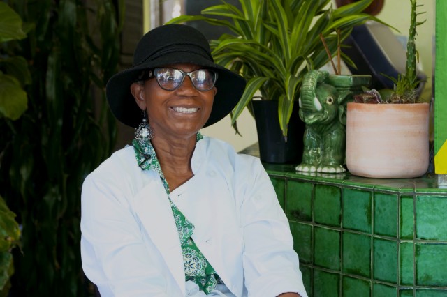 Marlene Beckford wearing hat and glasses