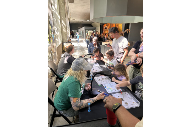 Children sorting fossils at a table