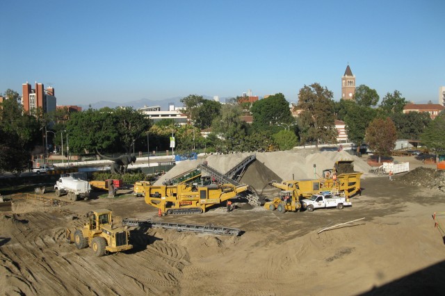 Earth movers prepare the NHM Nature Gardens grounds piling dirt in the background
