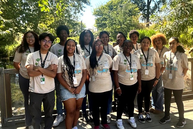 Group of teens standing with trees in the background