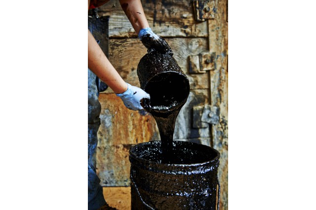 Photograph of "tar" being poured from a bucket